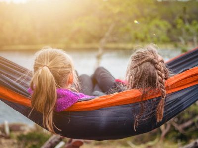 two women lying on hammock