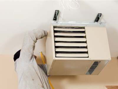 a man fixing a heater