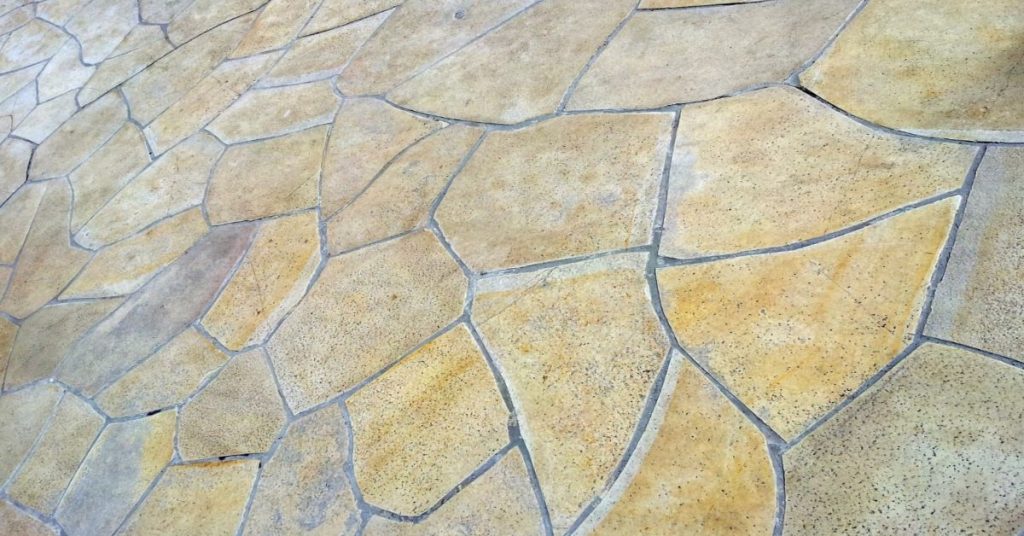A close-up shot of a yellow-ish limestone tiles on the floor.