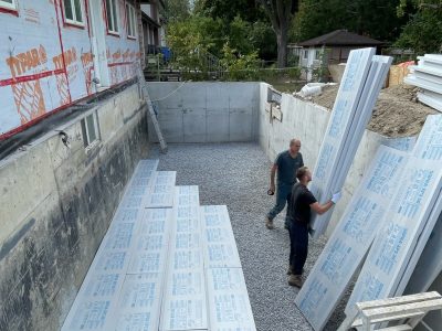 New concrete floor being installed during a basement renovation project