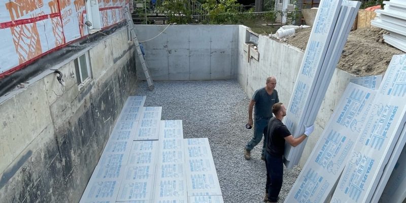 New concrete floor being installed during a basement renovation project